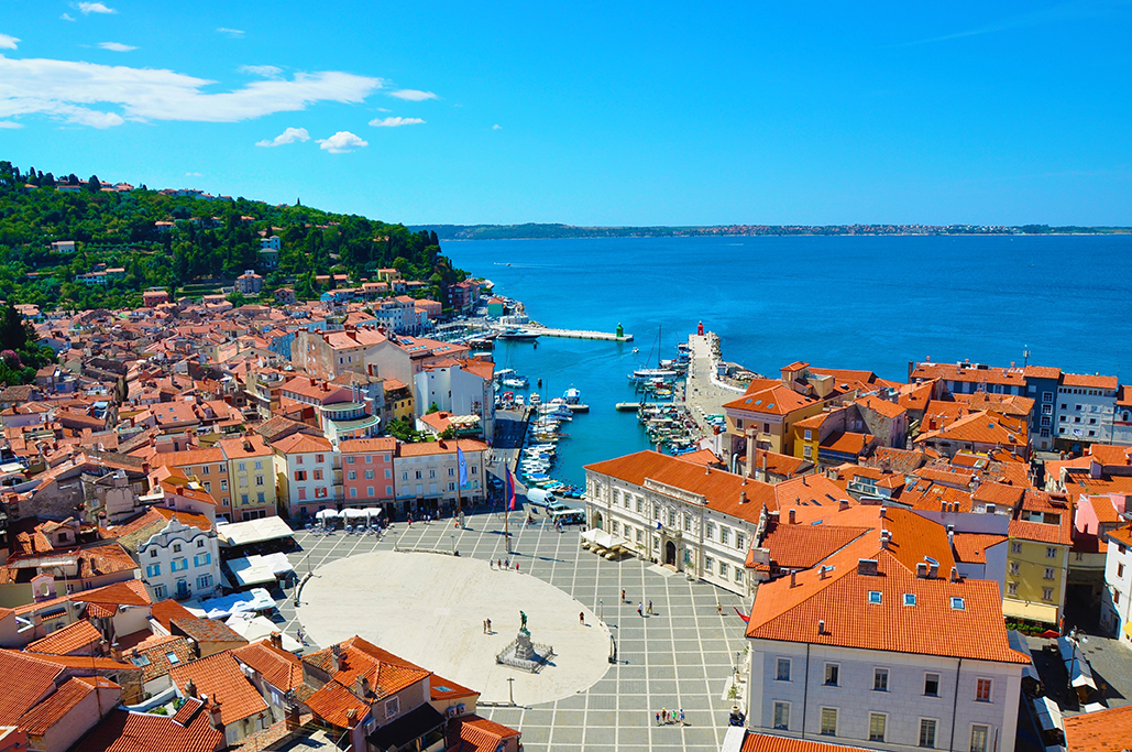 A bird's eye view of Piran's red roofs and Adriatic Sea