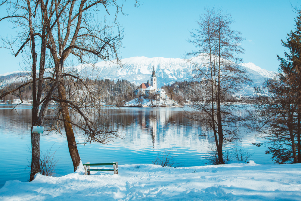 A landscape of Lake Bled and Bled Island on a snowy day